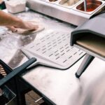 Lifestyle-Ooni-Perforated-Pizza-Peel-Serving3.jpg